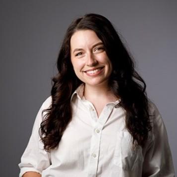 Woman with dark hair and white shirt