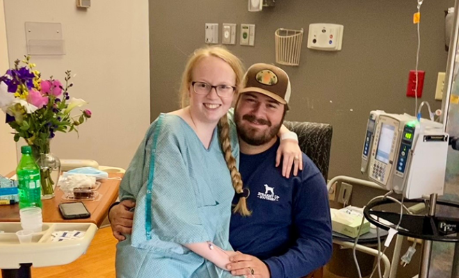 Madison in a hospital gown with her husband.