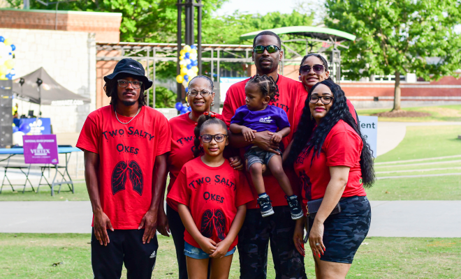 Rena Barrow and her families, all wearing red t-shirts that read "Two Salty Okes" at their local Great Strides event