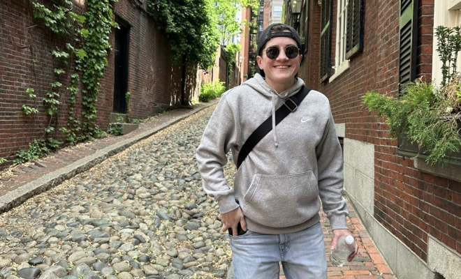 Steph Hansen smiling and walking down a cobblestone road