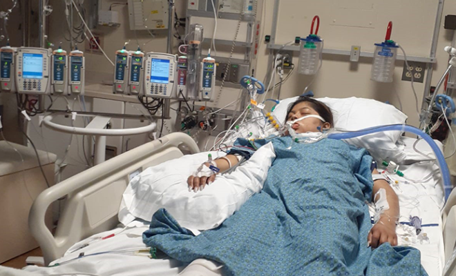 Tania laying in her hospital bed after transplant.