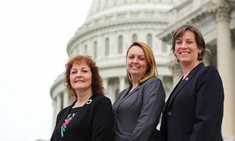 Three advocates pose outside during 2014's March on the Hill. 